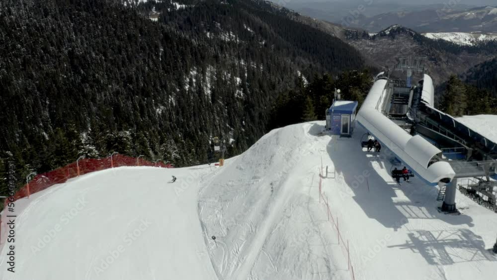 Skiers on ski the track at slopes. Skiing down from the high slopes. Mountain life in winter