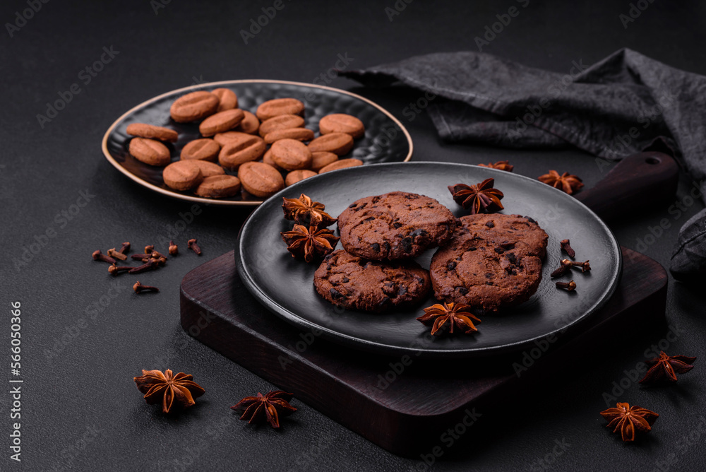Delicious chocolate cookies with nuts on a black ceramic plate Delicious chocolate cookies with nuts on a black ceramic plate