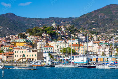 Sanremo  Italy   day view from the sea with boats and yachts to the old town of Sanremo  La Pigna  and Madonna della Costa Church on the hilltop  Liguria  Italy