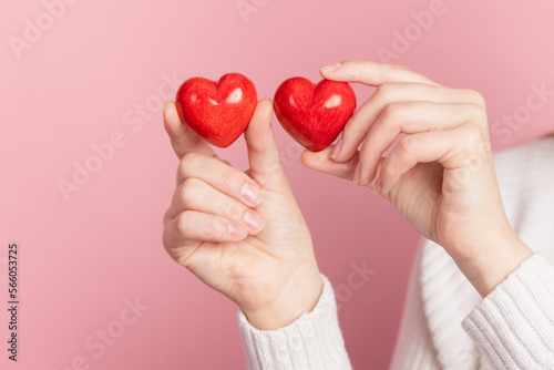 closeup hands holding heart on pink background  valentine s day concept