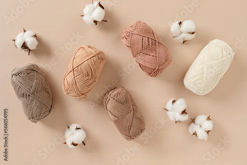 Craft knitting hobby background with yarn in natural colors. Recomforting hobby to reduce stress for cold fall and winter weather. Mock up, copy space, top view photo