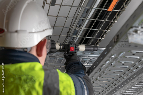 Steel Cable management baskets and trays with modular wiring, T conduit connector, drum of armoured cable, electrical installation