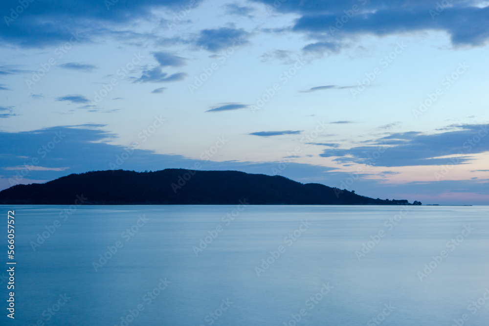 Sea background with island on the horizon. Blue seascape for publication, design, poster, calendar, post, screensaver, wallpaper, postcard, banner, cover, website. High quality photo