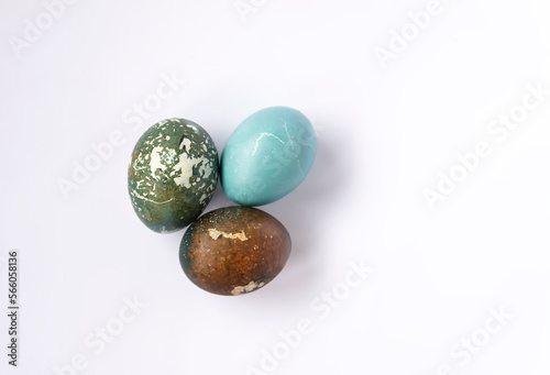 Colorful eggs on white background. Traditional homemade decor and food for Easter holidays.