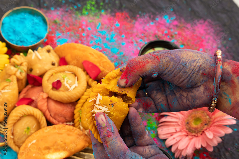 Φωτογραφία Hands Of A Girl Painted With Colorful Gulal Holding Delicious Gujiya Also Called