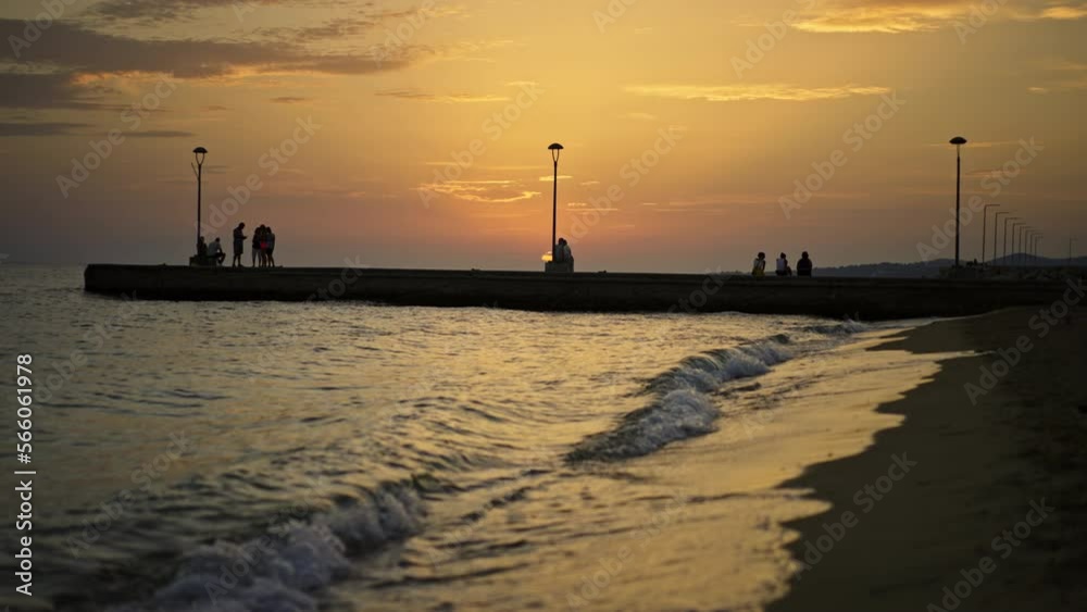 Amazing static view of ocean water surface. Tourists enjoying holiday on the beach and taking photos of nature in slow-motion at sunset Amazing static view of ocean water surface. Tourists enjoying holiday on the beach and taking photos of nature in slow-motion at sunset
