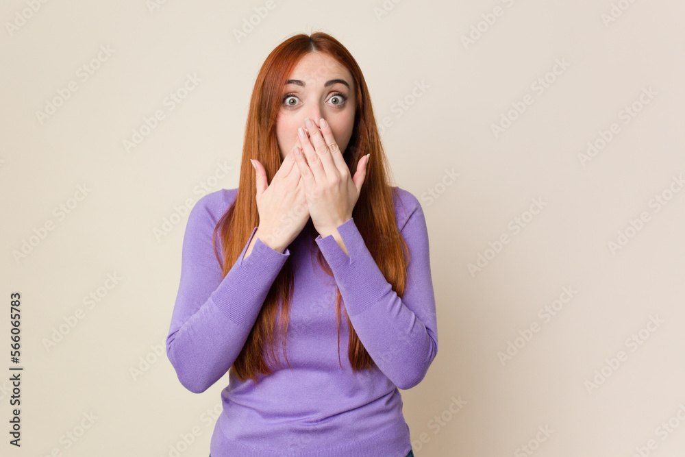 Young red hair woman isolated shocked, covering mouth with hands, anxious to discover something new. Young red hair woman isolated shocked, covering mouth with hands, anxious to discover something new.