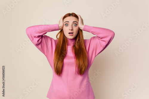 Young red hair woman isolated being shocked, she has remembered important meeting.