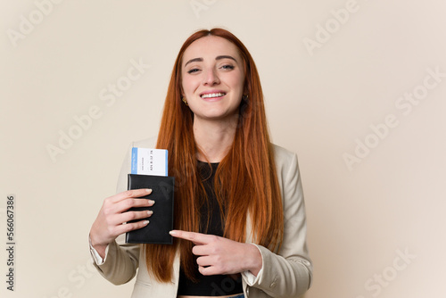 Young red hair business woman holding a flight tickets isolated