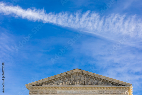 Partial View of the United States Supreme Court Building with blue Sky and Contrails Copy Space