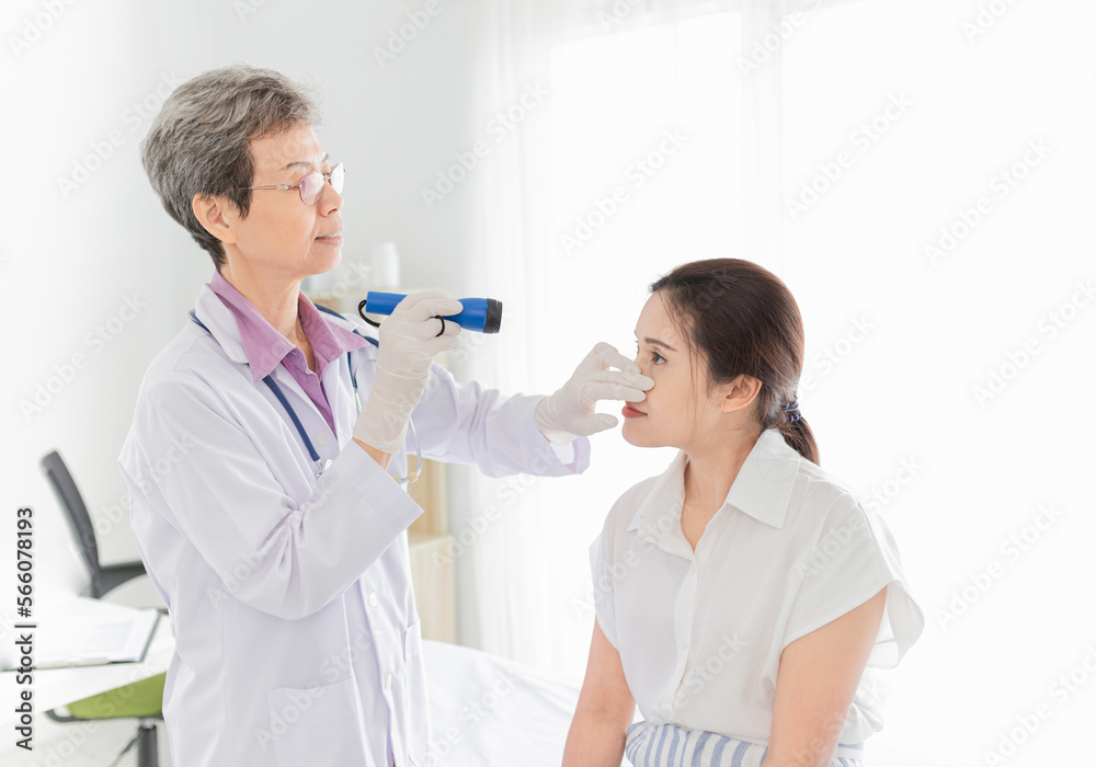 doctor use flashlight screening conjunctivitis patient, asian patient has red eyes and feeling pain, infection eye doctor use flashlight screening conjunctivitis patient, asian patient has red eyes and feeling pain, infection eye