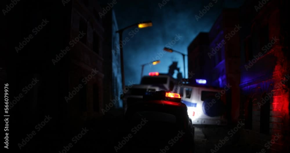 Police raid at night and you are under arrest concept. Silhouette of police car on backside. Image with the flashing red and blue police lights at foggy background. Police raid at night and you are under arrest concept. Silhouette of police car on backside. Image with the flashing red and blue police lights at foggy background.