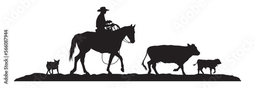 A vector silhouette of a working ranch cowboy riding a horse . The cowboy is holding a lasso rope and herding a cow and young calf. His cow dog follows closely behind. © LUGOSTOCK