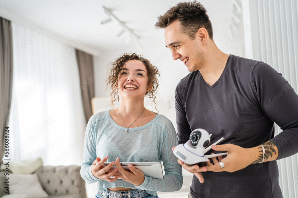 man and woman couple wife husband set up surveillance security camera man and woman couple wife husband set up surveillance security camera