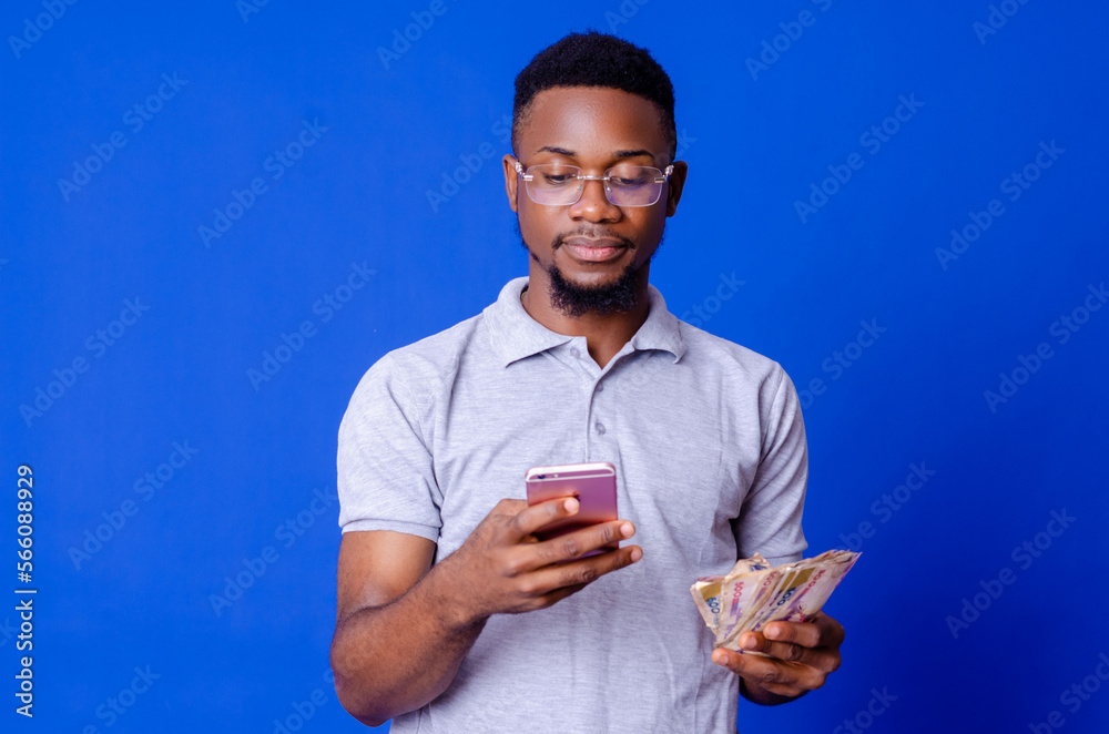 young african businessman holding a lot of money and using his phone young african businessman holding a lot of money and using his phone