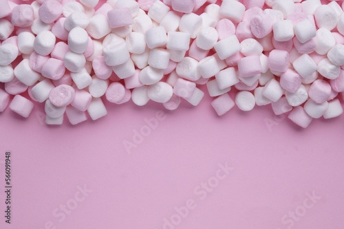 Delicious marshmallows on pink background, flat lay. Space for text