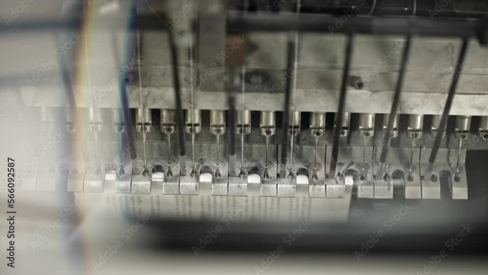 Printing machine moving on the production line, paper moving under, looking from above. Printing machine moving on the production line, paper moving under, looking from above.