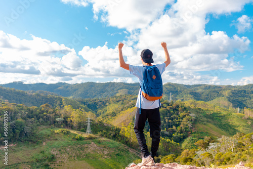 Quadro em tela Man standing and celebrating after reaching the top of the mountain and contemplating the beautiful view of the mountains