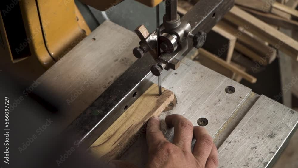 Close shot of a machine that is cutting small piece of wood Close shot of a machine that is cutting small piece of wood