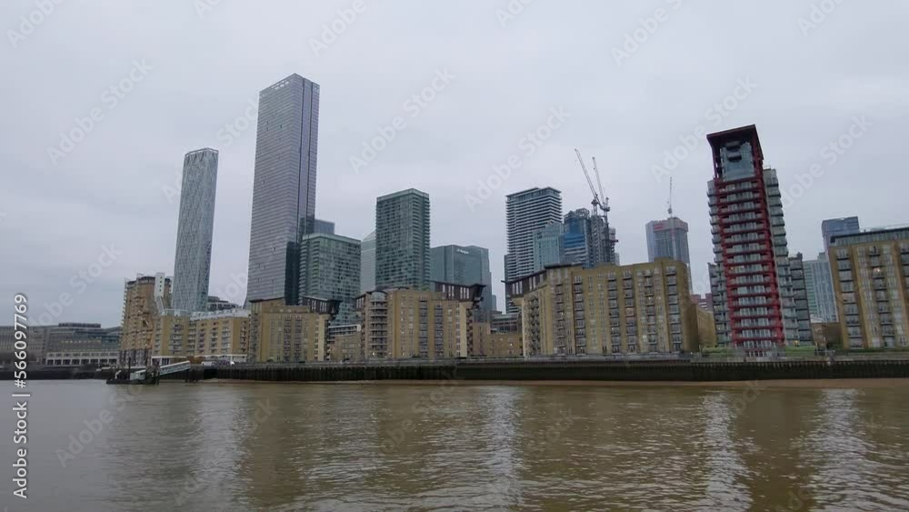 Canary Wharf in a gloomy London, taken from a boat on the river Thames. Showing a financial district with high buildings and a skyline. Canary Wharf in a gloomy London, taken from a boat on the river Thames. Showing a financial district with high buildings and a skyline.