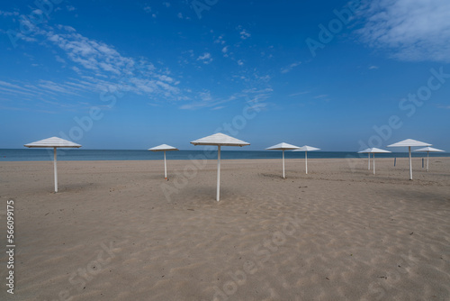 A deserted beach with wooden umbrellas on the shore of the Baltic Sea in the village of Yantarny  Kaliningrad region  Russia