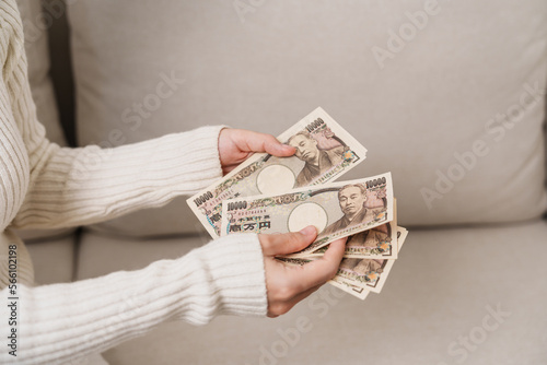 Woman hand holding Japanese Yen banknote stack. Thousand Yen money. Japan cash, Tax, Recession Economy, Inflation, Investment, finance and shopping payment concepts