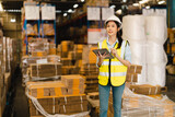 Portrait of Asian woman warehouse supervisor working distribution warehouse to managing inventory and logistics.