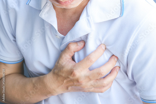 Canvas-taulu Man is sick and in pain and uses his hands to squeeze his chest He had chest pain caused by an acute heart attack