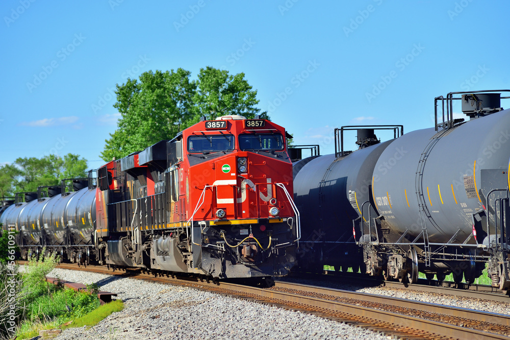 A Canadian National Railway oil train, at left, holding on a siding ...