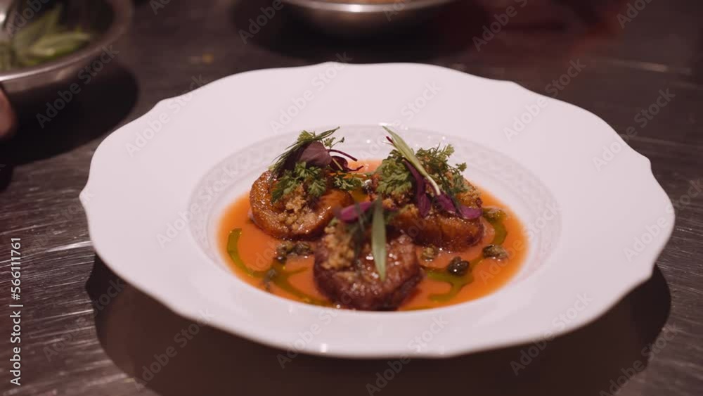 Close up panning shot of a delicious Italian dish prepared by the cook on a round white plate. Close up panning shot of a delicious Italian dish prepared by the cook on a round white plate.