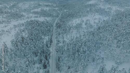 Drone shot of EV Opel Ampera driving in beautiful big snowy landscape in Norway. photo