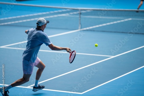 Tennis player serving in a tennis match, with leg drive in a game of sport © William