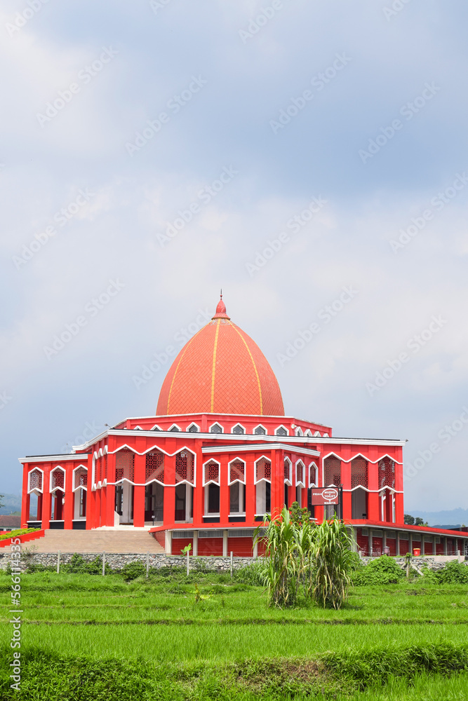 Fototapeta premium Moekhlas Sidik Mosque, Pandaan District, Pasuruan, East Java, Indonesia. in the morning with blue sky and white clouds. Because red colored, it also called Red Mosque