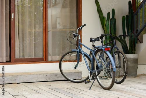 Classic bike in front of house in natural sunlight.