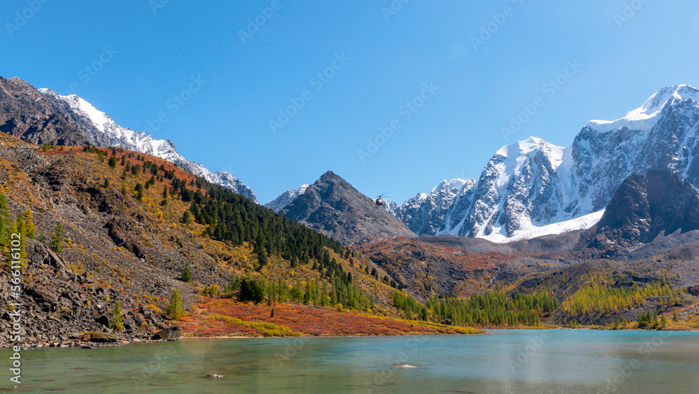 Panorama of Lake Verkhnee-Shavlinskoye against the backdrop of mountains with glaciers and snow in Altai during the day. Peaks Dream, Fairy Tale, Beauty.