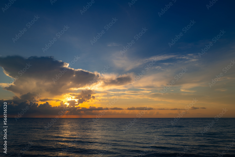Sea beach with sky sunset or sunrise. Cloudscape over the sunset sea. Sunset at tropical beach. Nature sunset sky of sea. Dramatic clouds.