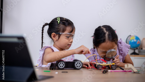 Asian students learn at home by coding robot cars and electronic board cables in STEM, STEAM, mathematics engineering science technology computer code in robotics for kids' concepts.