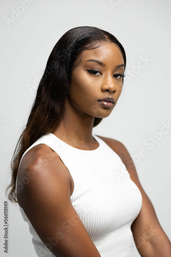 model in neutral clothing in front of white photography backdrop background modeling black african american dark complexion beautiful gorgeous jeans white top digitals headshots recruitment