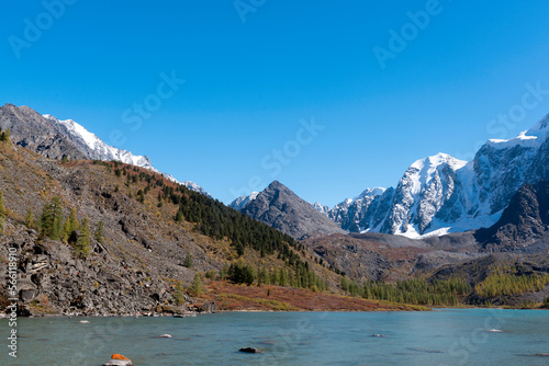 Snowy mountain peaks with glaciers near the alpine transparent lake Shavlinskoye in Altai in the autumn afternoon. Peaks Dream, Fairy Tale, Beauty. © Дмитрий Седаков