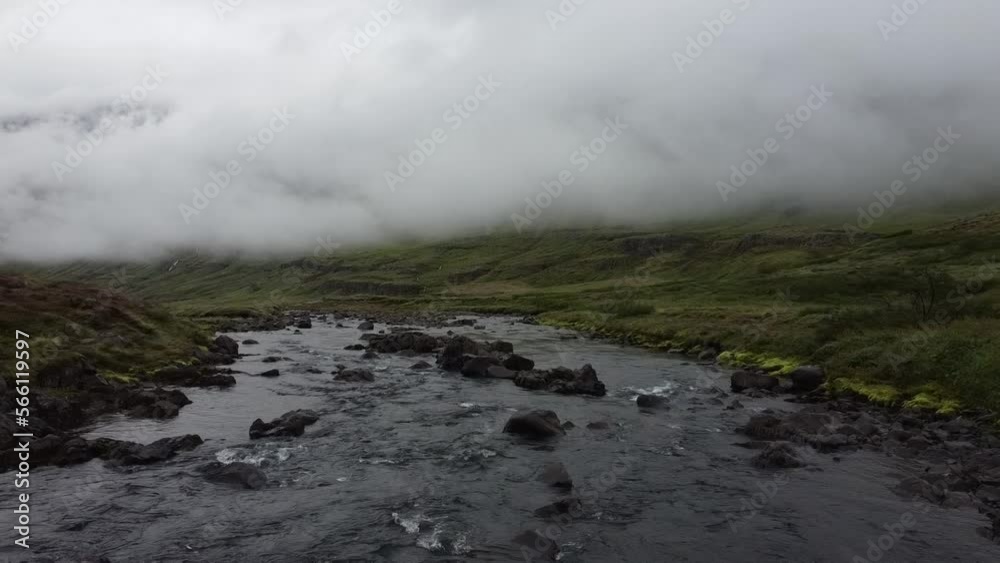 Shallow rocky mountain river in Iceland in foggy day, drone view above water Shallow rocky mountain river in Iceland in foggy day, drone view above water