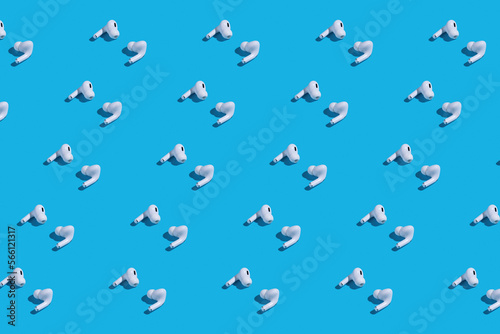 Rows of white earbuds on blue background