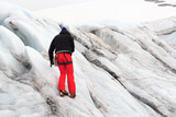 Man trains to mountaineer with crampons on glacier Pasterze in Glockner Group, Austria