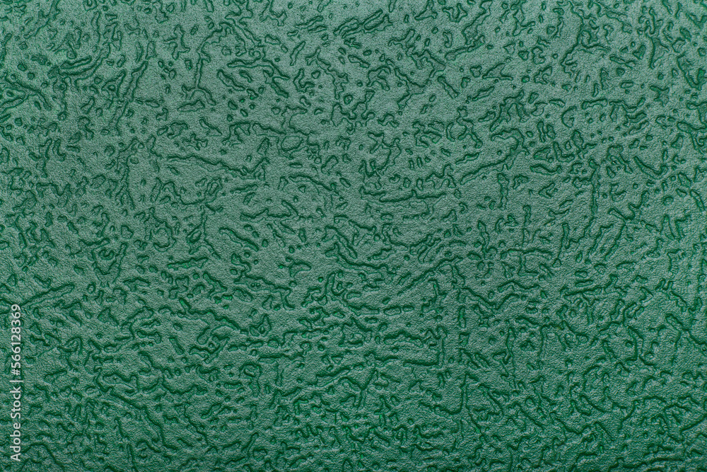 Green background with patterns. Textured green wallpaper on the wall. Green background with patterns. Textured green wallpaper on the wall.