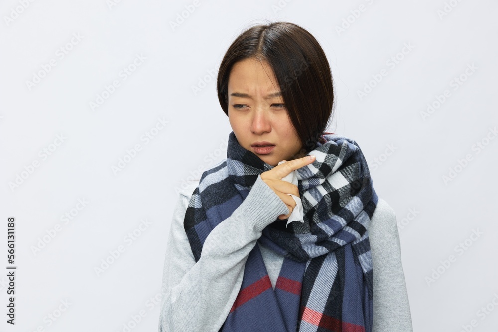 Asian woman cold flu holding handkerchief stuffed nose and coughing with fever sick from virus on white background, copy space Asian woman cold flu holding handkerchief stuffed nose and coughing with fever sick from virus on white background, copy space