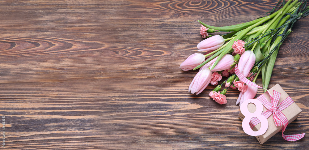 Bouquet of flowers, gift and figure 8 on wooden background with space for text. International Women's Day Bouquet of flowers, gift and figure 8 on wooden background with space for text. International Women's Day