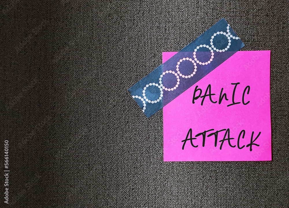 Paper note stick on dark wallpaper background written PANIC ATTACK