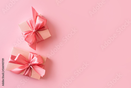 Pink gift box with bow on pink background