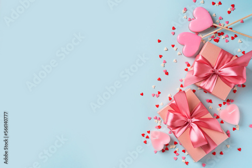 Candy pink lollipops with red gift box on blue background