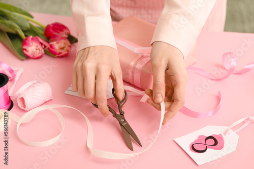 Woman making gift for International Women's Day celebration at table, closeup