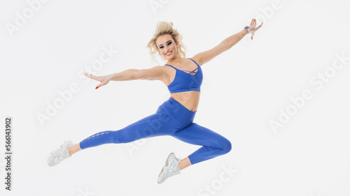 Support for your favourite team. A young female cheerleader jumps on a white isolated background. Bright makeup